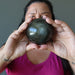 female model holding Gold Sheen Obsidian Sphere