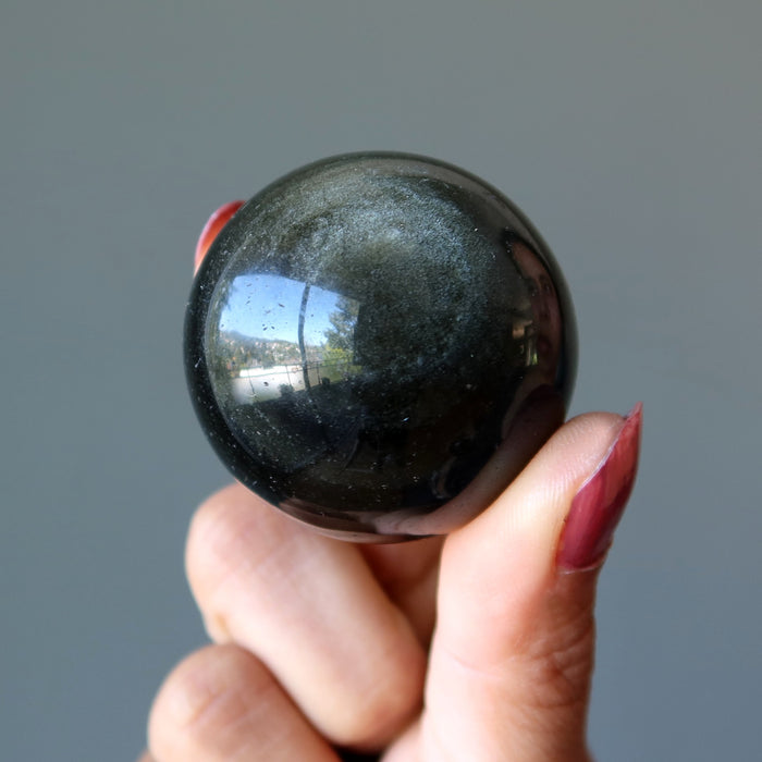 holding Gold Sheen Obsidian Sphere