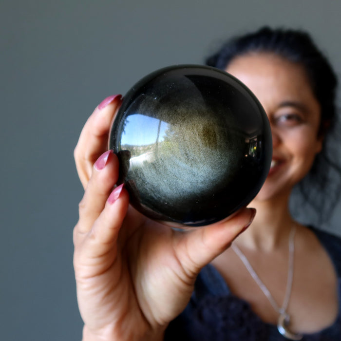 sheila holding Gold Sheen Obsidian Sphere