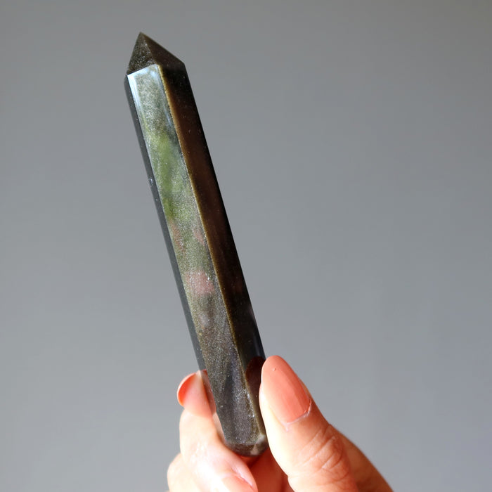 hand holding Faceted Gold Sheen Obsidian Wand