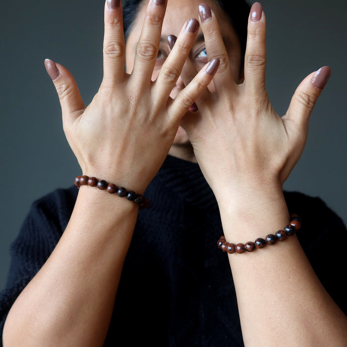 mahogany obsidian bracelets on hands