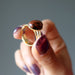 hand holding mahogany obsidian gold ring