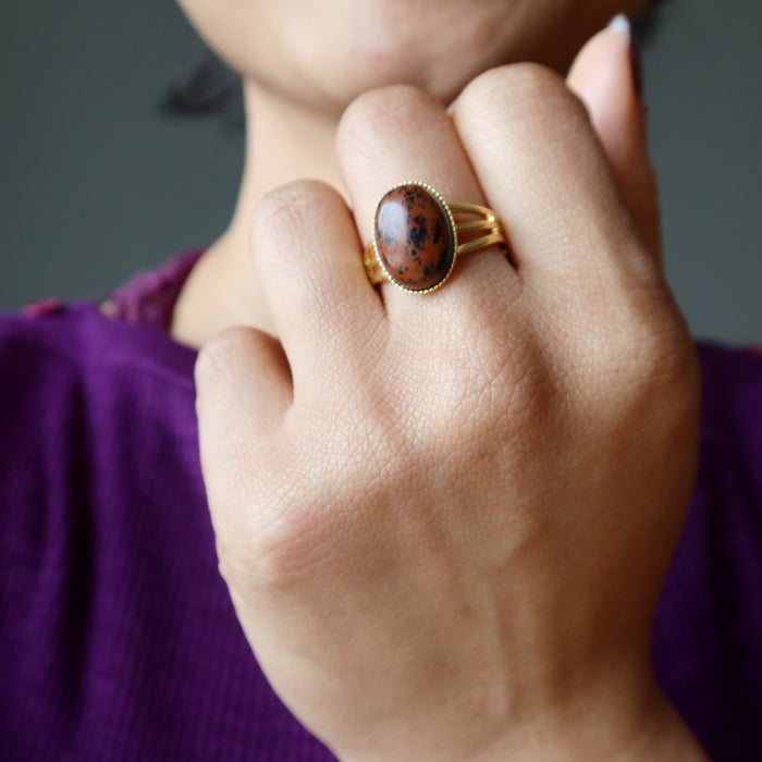 hand wearing mahogany obsidian gold ring