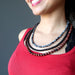 woman wearing triple strand obsidian necklace
