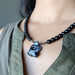 snowflake obsidian turtle necklace on neck