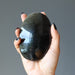 sheila of satin crystals holding gold sheen obsidian oval palm stone