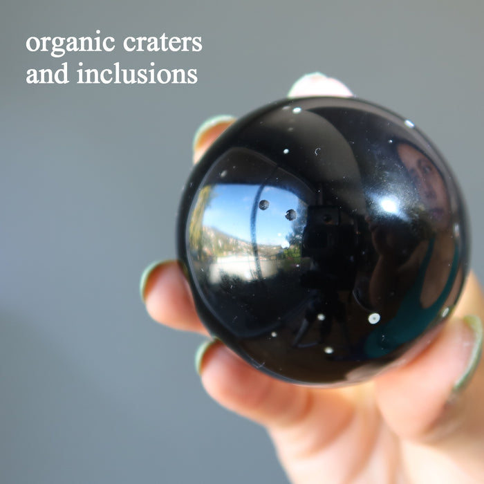 purple obsidian sphere with white snowflake craters