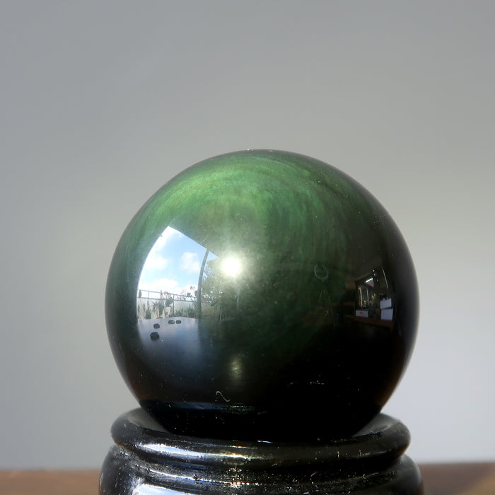 green sheen rainbow obsidian sphere on stand