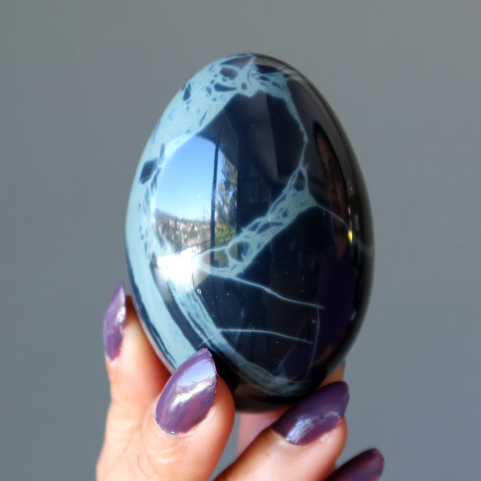 hand holding Spiderweb Obsidian Egg