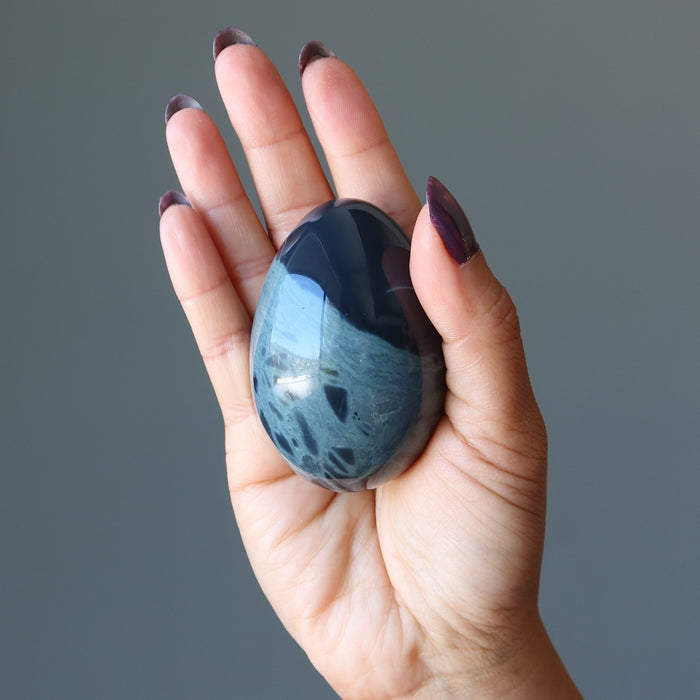 holding Spiderweb Obsidian Egg in the palm