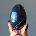 fingers holding Spiderweb Obsidian Egg