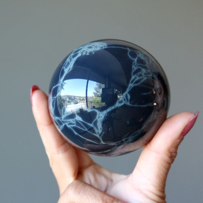 holding Spiderweb Obsidian Sphere 