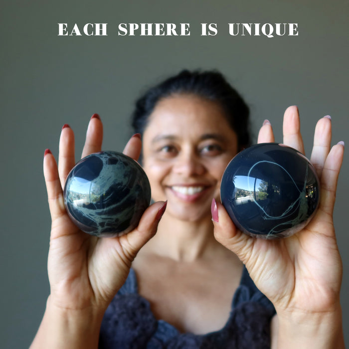sheila holding 2 Spiderweb Obsidian Spheres