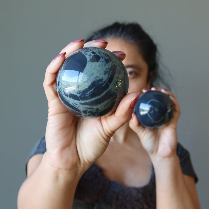 sheila holding big and small Spiderweb Obsidian Spheres