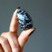hand holding snowflake obsidian tumbled stone