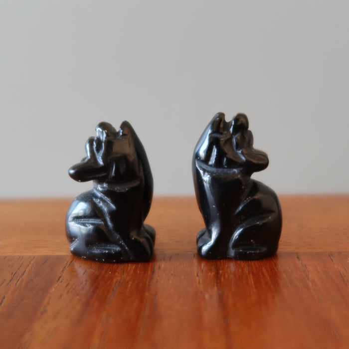 two 1" Black Obsidian Wolves on the table
