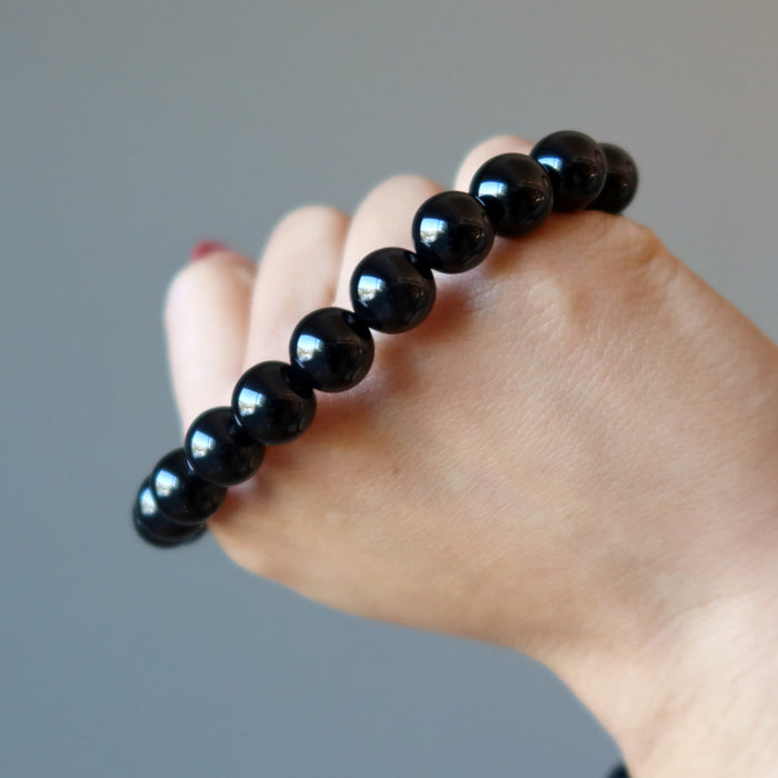 hand wearing black onyx bracelet