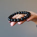 hand holding out black onyx bracelet
