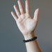 hand wearing black onyx bracelet
