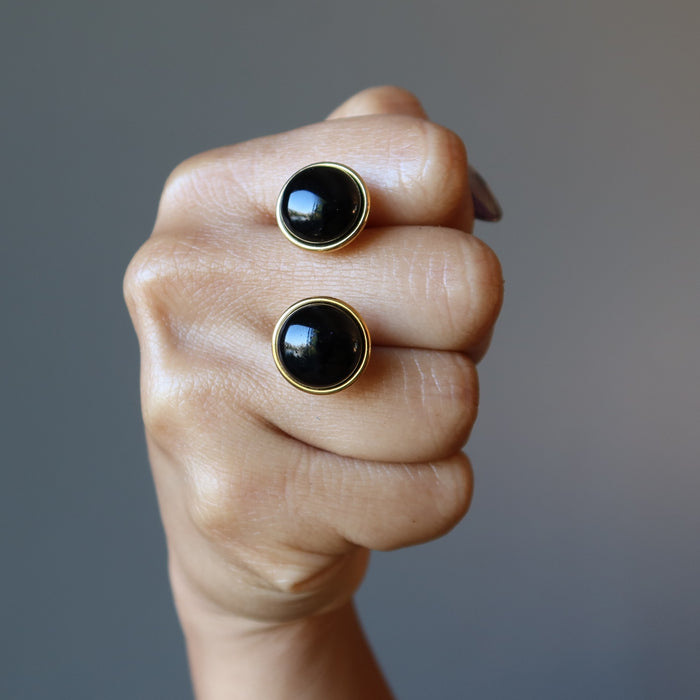 fist holding black onyx cufflinks