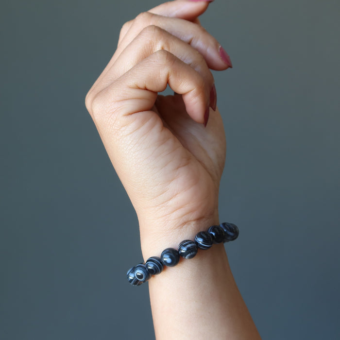 hand modeling a black and white onyx stretch bracelet