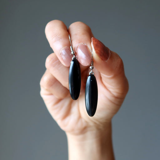 hand holding black onyx oval earrings