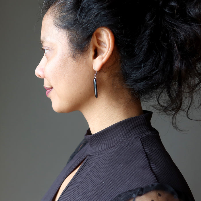 female wearing black onyx oval earrings