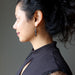 female wearing black onyx oval earrings