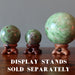 3 green opal spheres on wood display stands, which are sold separately