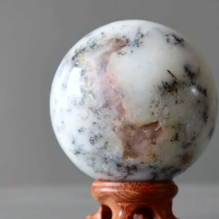 white opal sphere on wood display stand