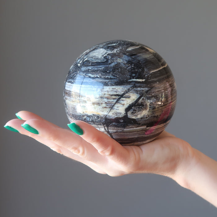 palm holding a Black Opal Sphere