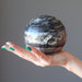 palm holding a Black Opal Sphere
