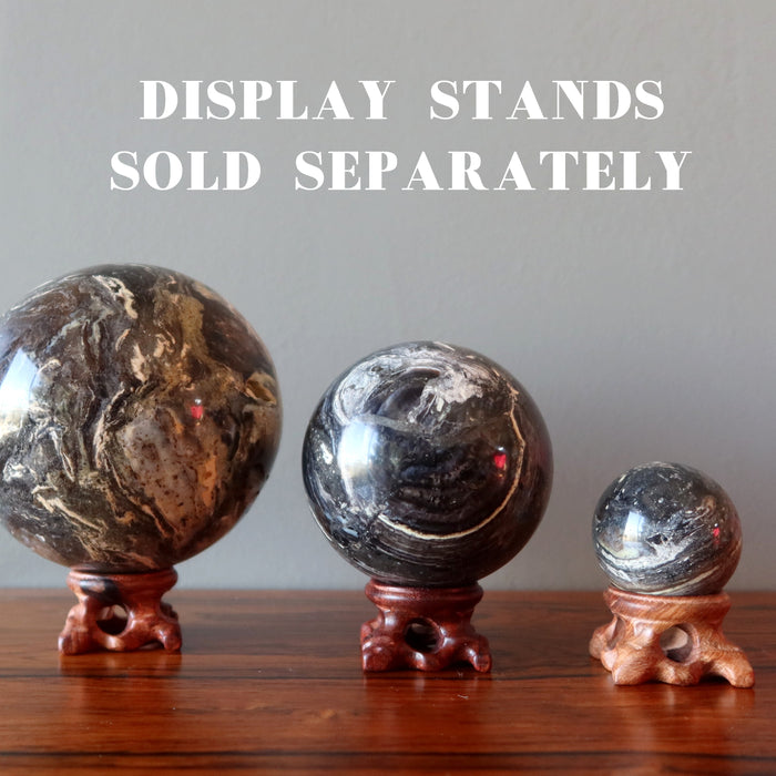 displaying three different sizes of Black Opal Spheres