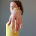 jamie of satin crystals wearing a round yellow opal beaded stretch bracelet