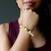 model with hand on chin wearing yellow opal beaded bracelet