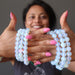 Sheila Satin of Satin Crystals holds six handmade Opalite bracelets 