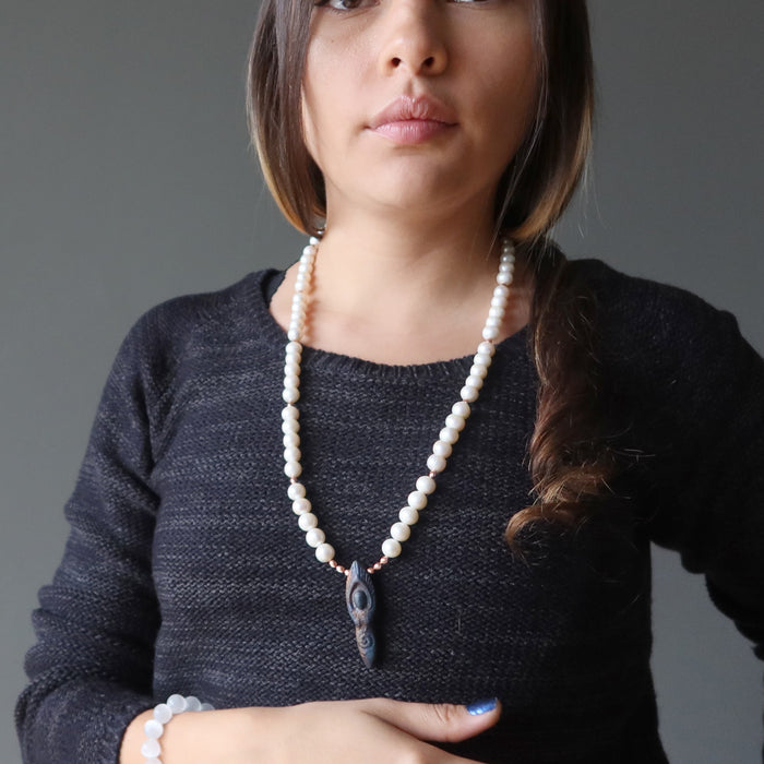 woman modeling pearl goddess necklace