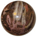 brown and pink petrified wood sphere