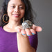 sheila of satin crystals holding a gold pyrite geode sphere