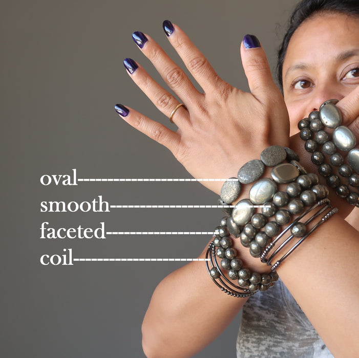 sheila of satin crystals with two hands stacked with different types of pyrite bracelets