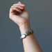 hand wearing pyrite oval stretch bracelet