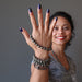 Sheila Satin of Satin Crystals wears faceted Pyrite bracelets on her hand while smiling
