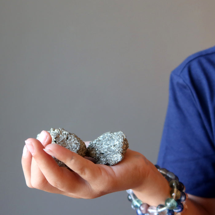 kid holding raw pyrite clusters