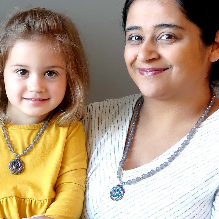 mother and daughter wearing matching pyrite rose necklaces