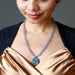 female wearing pyrite rose and chalcedony necklace