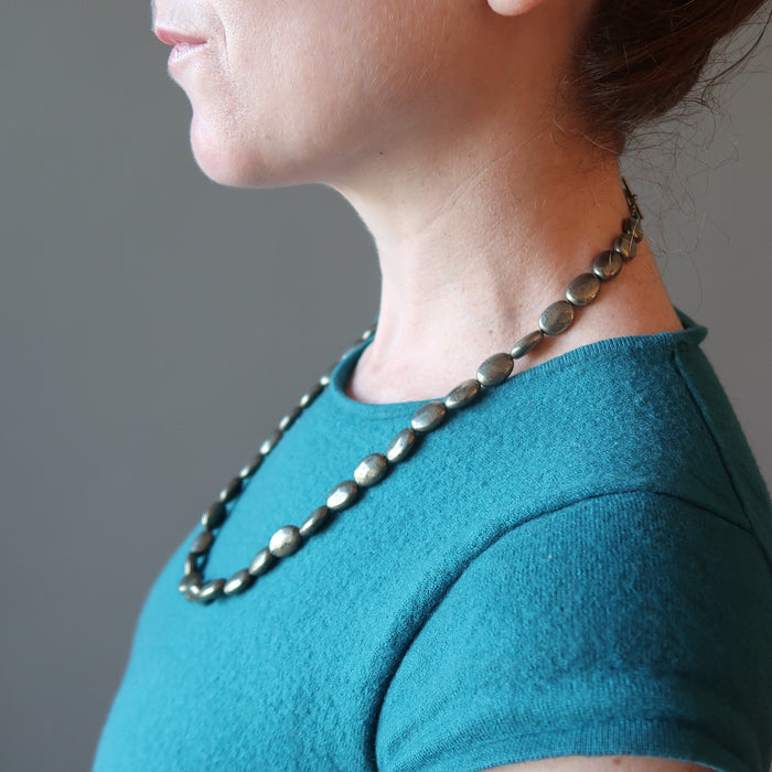 woman wearing pyrite oval necklace