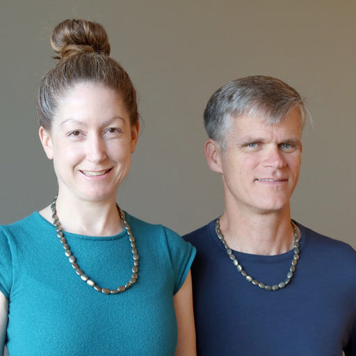 man and woman wearing pyrite oval necklaces
