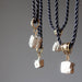4 raw pyrite nuggets on black twisted necklaces