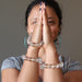 sheila of satin crystals with hands in prayer wearing clear quartz jewelry