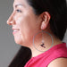 woman wearing quartz hummingbird hoop earrings